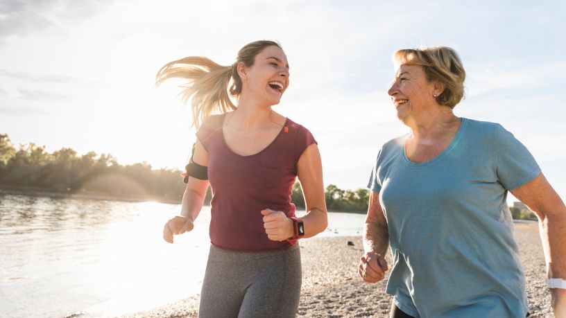 Two women going for a run together wearing smart watches.