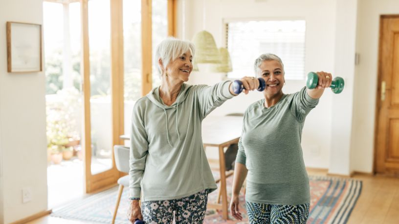 2 women doing weight training together.