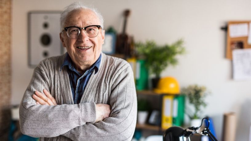 Older man with glasses smiling
