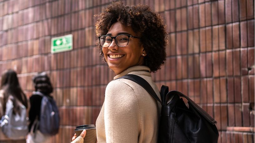 A young woman smiles over her shoulder.