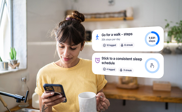 Woman holding mobile phone looking at Blua app showing reminders