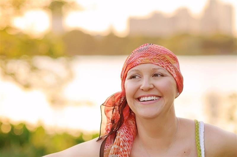 Woman wearing headscarf smiling outdoors