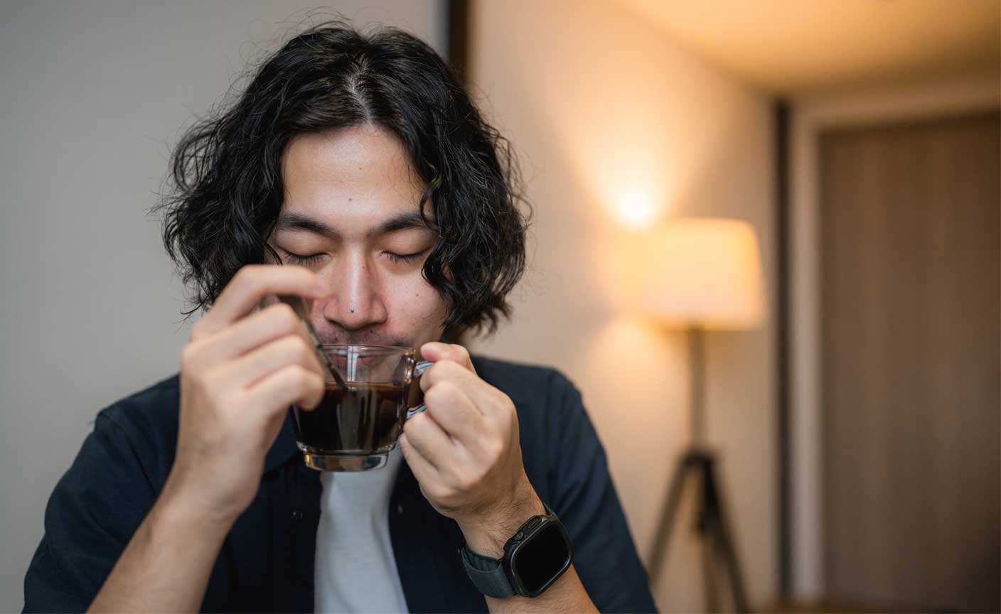 Male sipping on hot drink