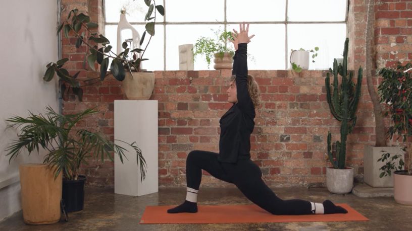 Kath Ebbs takes a yoga-inspired pose during their workout  