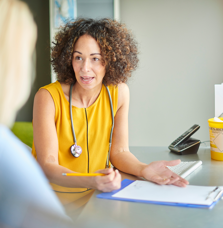 Doctor talks to a patient about their DNA test results.
