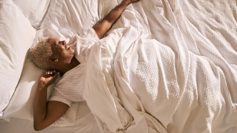 Woman lying in bed smiling