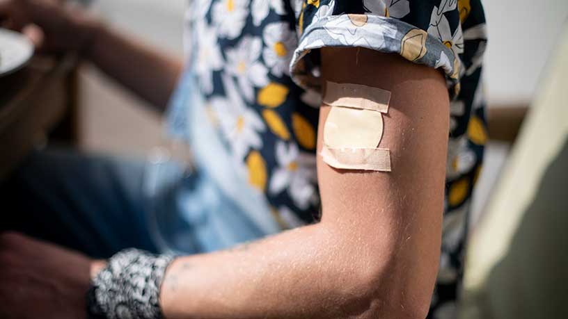 A nicotine patch on a persons arm