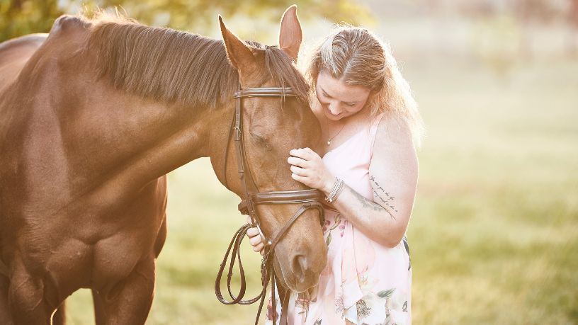Cindy hugging her horse.