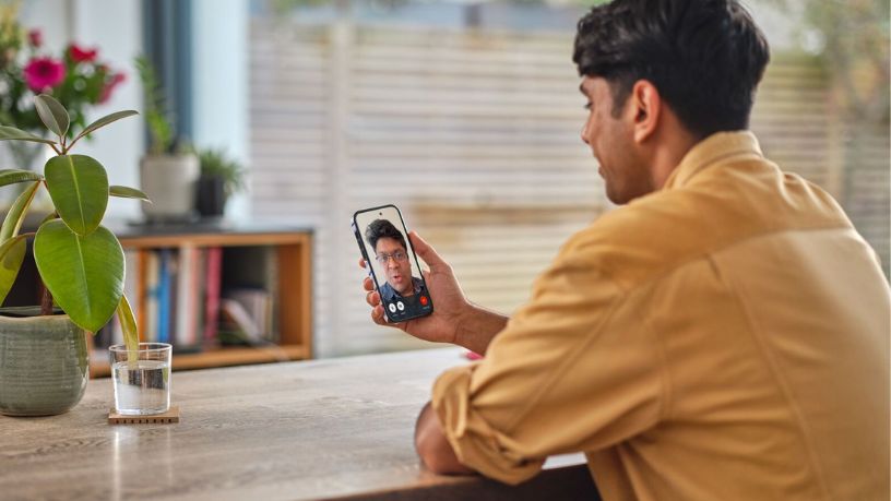 Young man on a video call to a doctor on his phone.