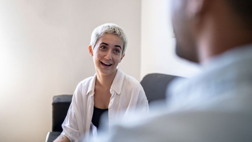 A man in a doctors clinic talking to a doctor.