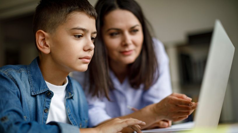 Mother and her son on the laptop together.