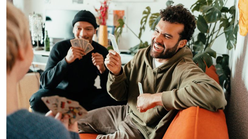 A group of people playing cards together.