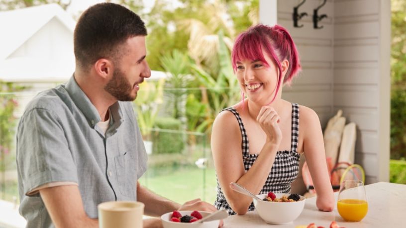 People have a conversation over breakfast.