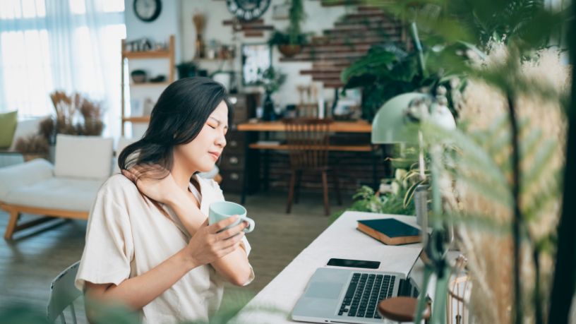 A women stretching a sore neck