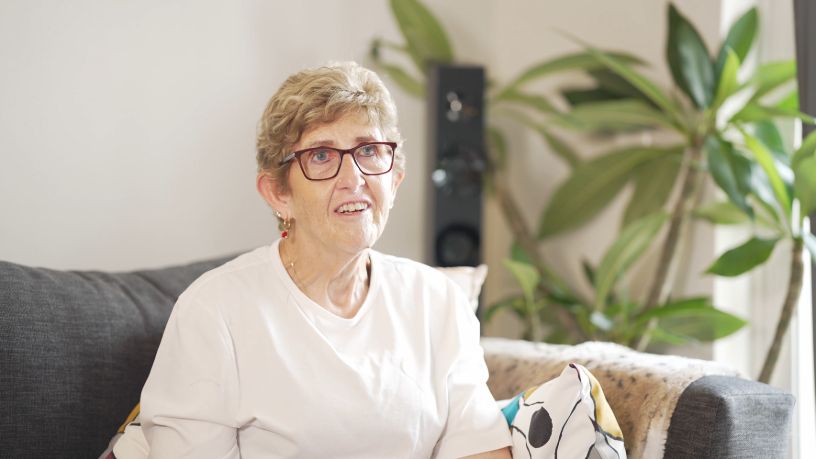 Michelle sits in her living room.