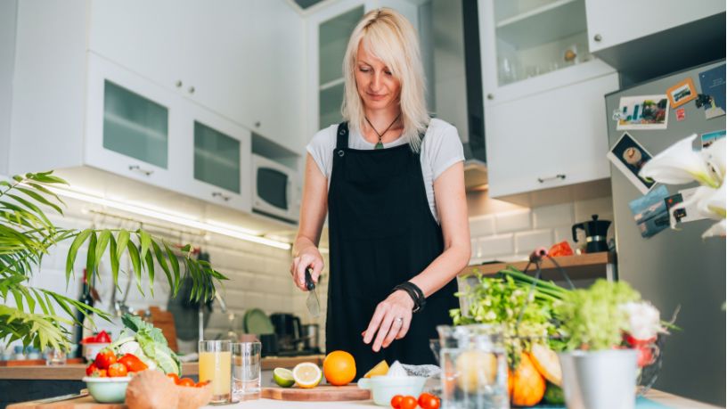 A woman in the kitchen preparing a healthy meal.