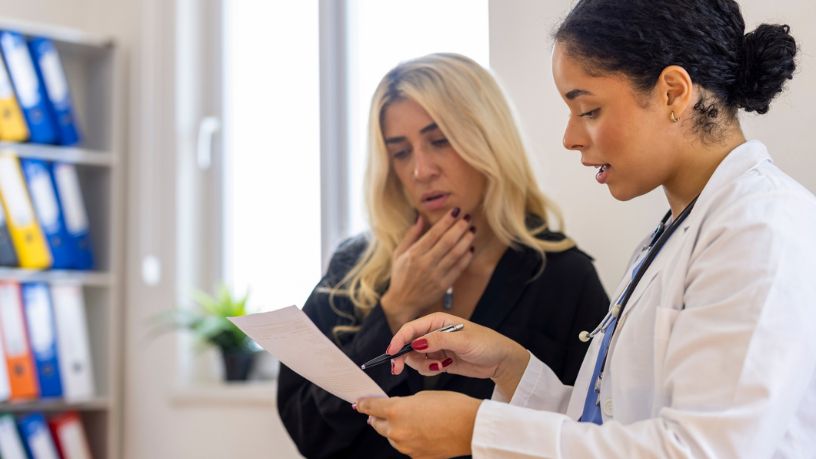 Female doctor explaining medical results on paper to patient
