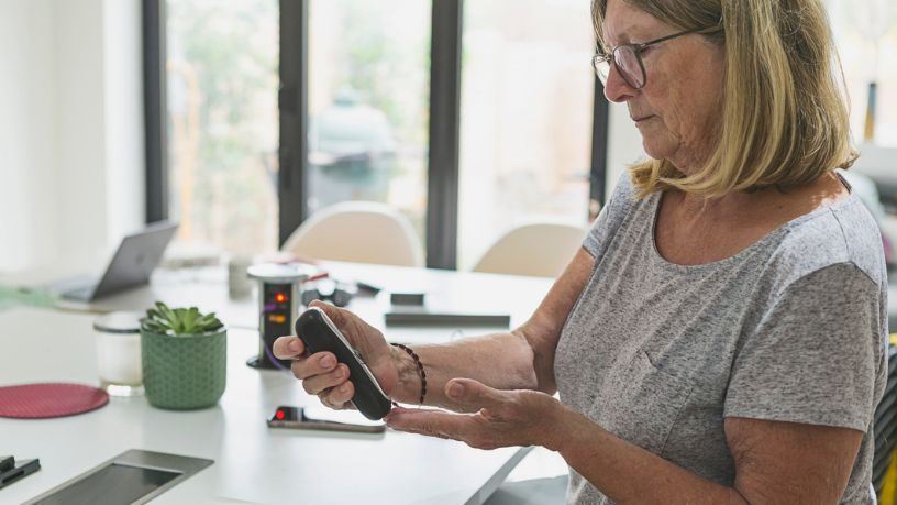 Woman monitoring her blood glucose levels at work.