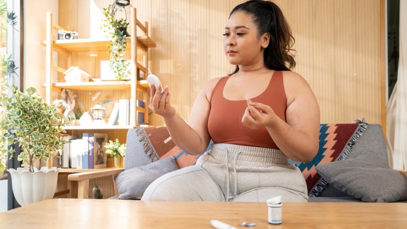 A woman testing her blood sugar