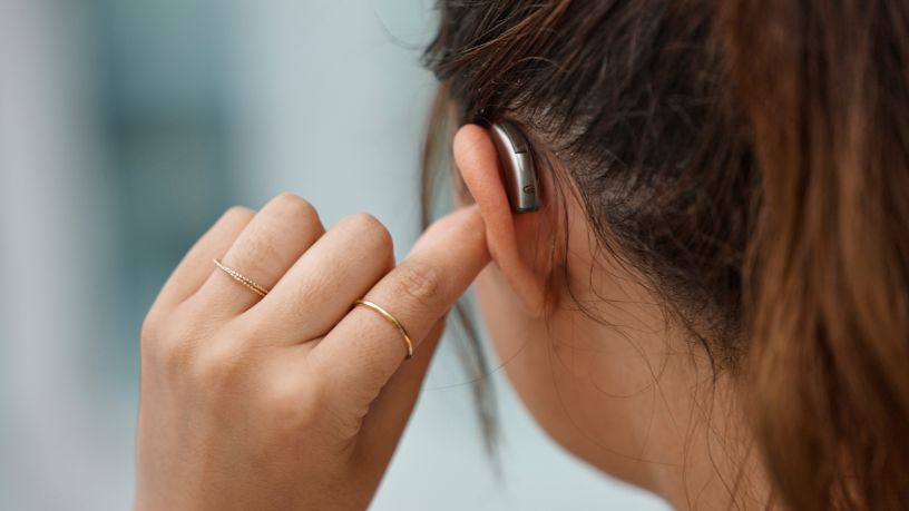 A person wearing a hearing aid.