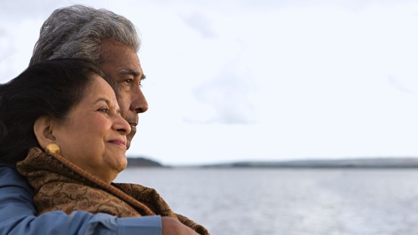 A couple look out over the ocean.