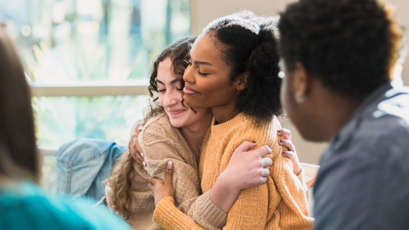 Two friends happily enjoying an embrace.