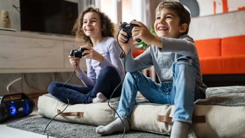 Two kids play video games together