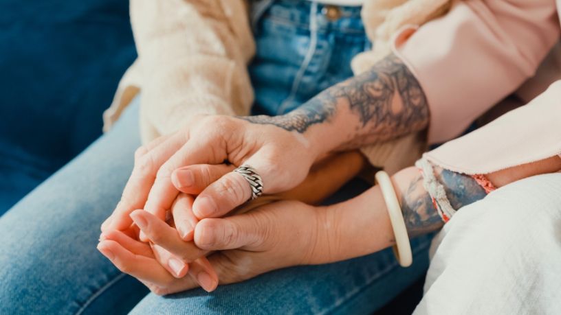 Two people holding hands.