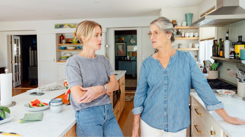 Woman talking to her mother in the kitchen