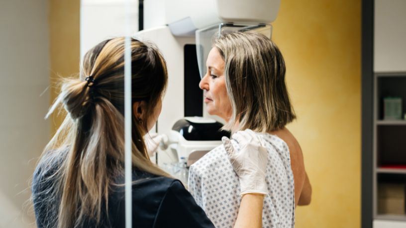 A woman at the clinic getting a mammogram.
