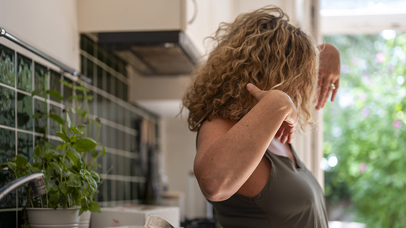 A woman with curly hair dancing.