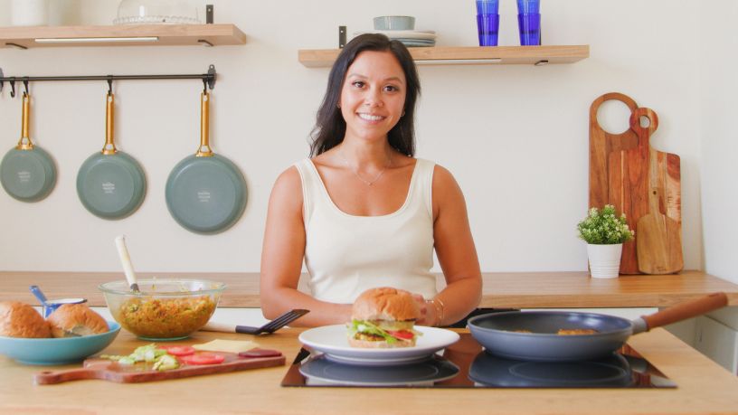 Riley standing in front of the red lentil burger.