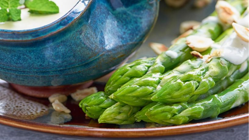 Chargrilled asparagus salad is arranged on a serving platter.