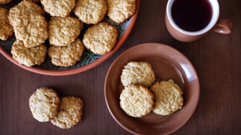 A table is filled with cookies and a cup of coffee.