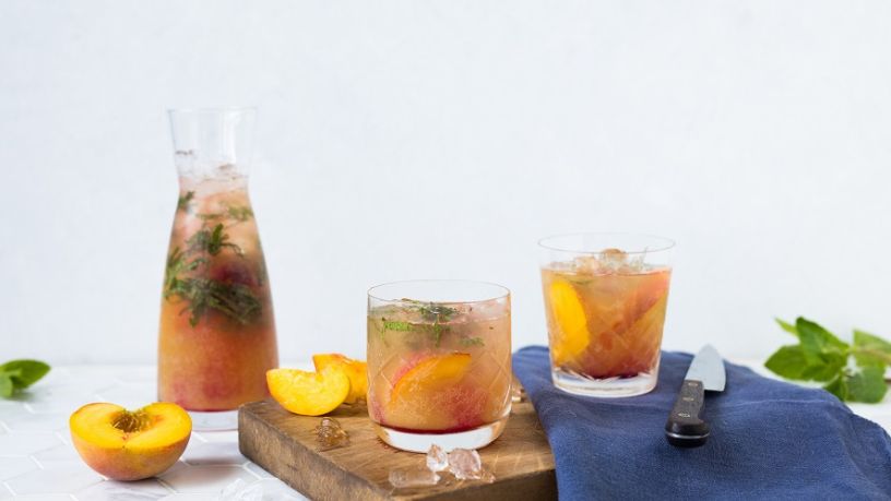 Jug of Kombucha spritz ready to serve with 2 glasses.