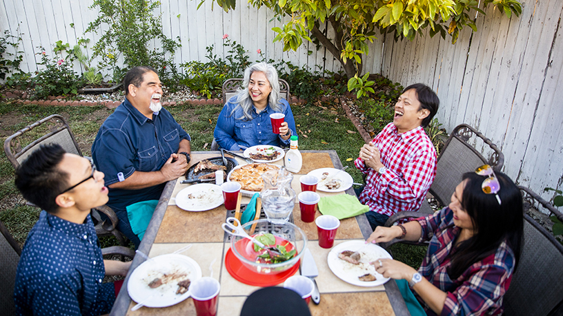 A family sitting down to a special meal outside.