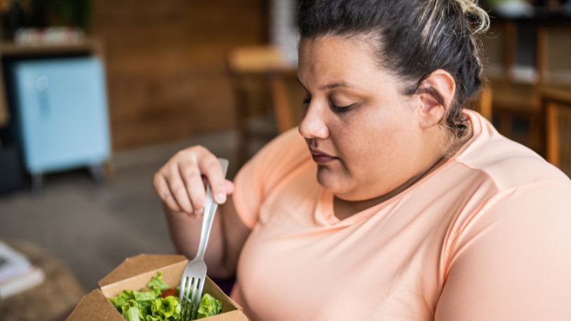 A woman eating a salad.  