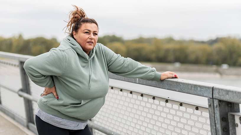 A woman resting while out exercising. 