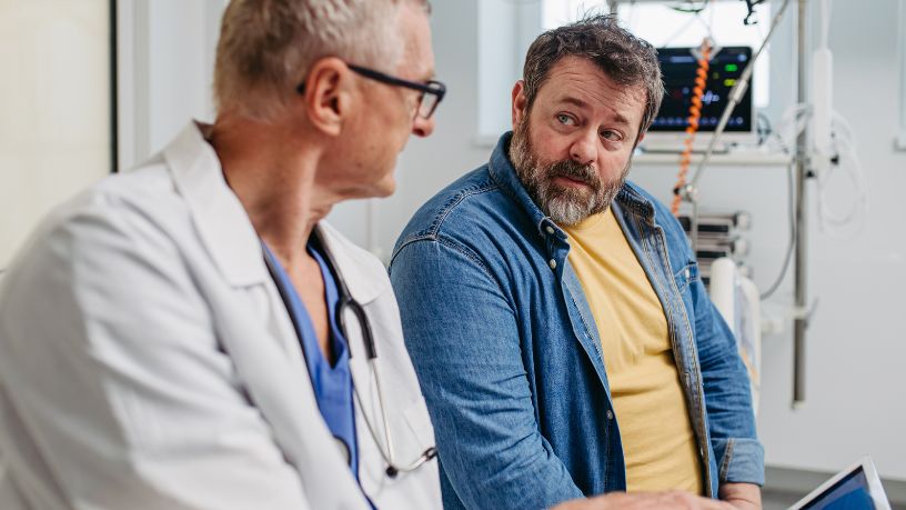 A man at the doctor asking about weight loss advice.