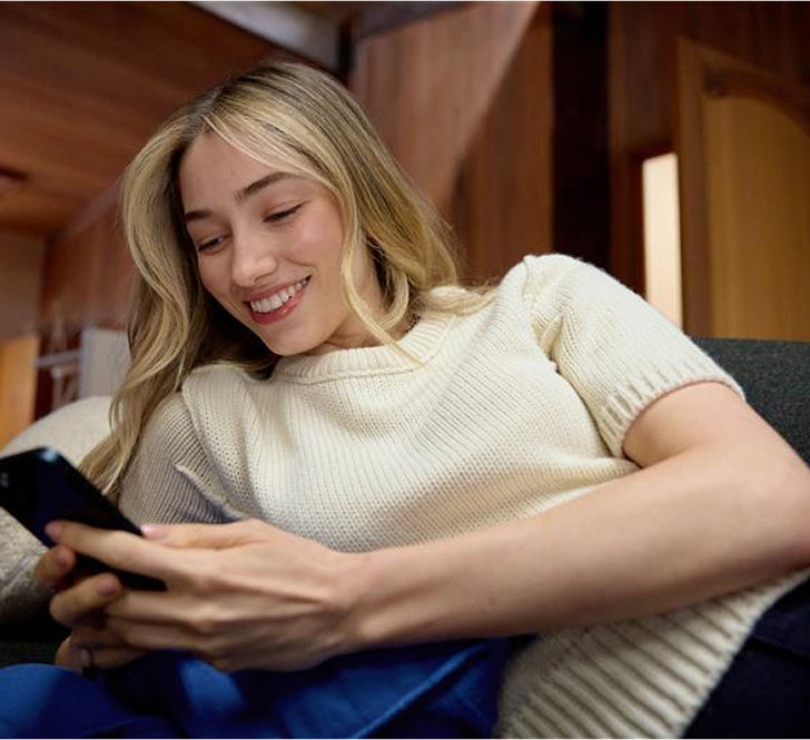 Woman smiling while using mobile app